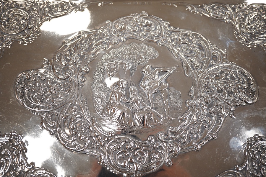 An Edwardian embossed silver dressing table tray, by Henry Matthews, Birmingham, 1901, length 32.1cm, 16.8oz.